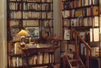 Lighted Lamp On Table In Library Study With Tall Bookshelves inside proportions 1122 X 1390