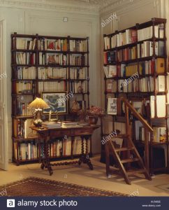 Lighted Lamp On Table In Library Study With Tall Bookshelves inside proportions 1122 X 1390