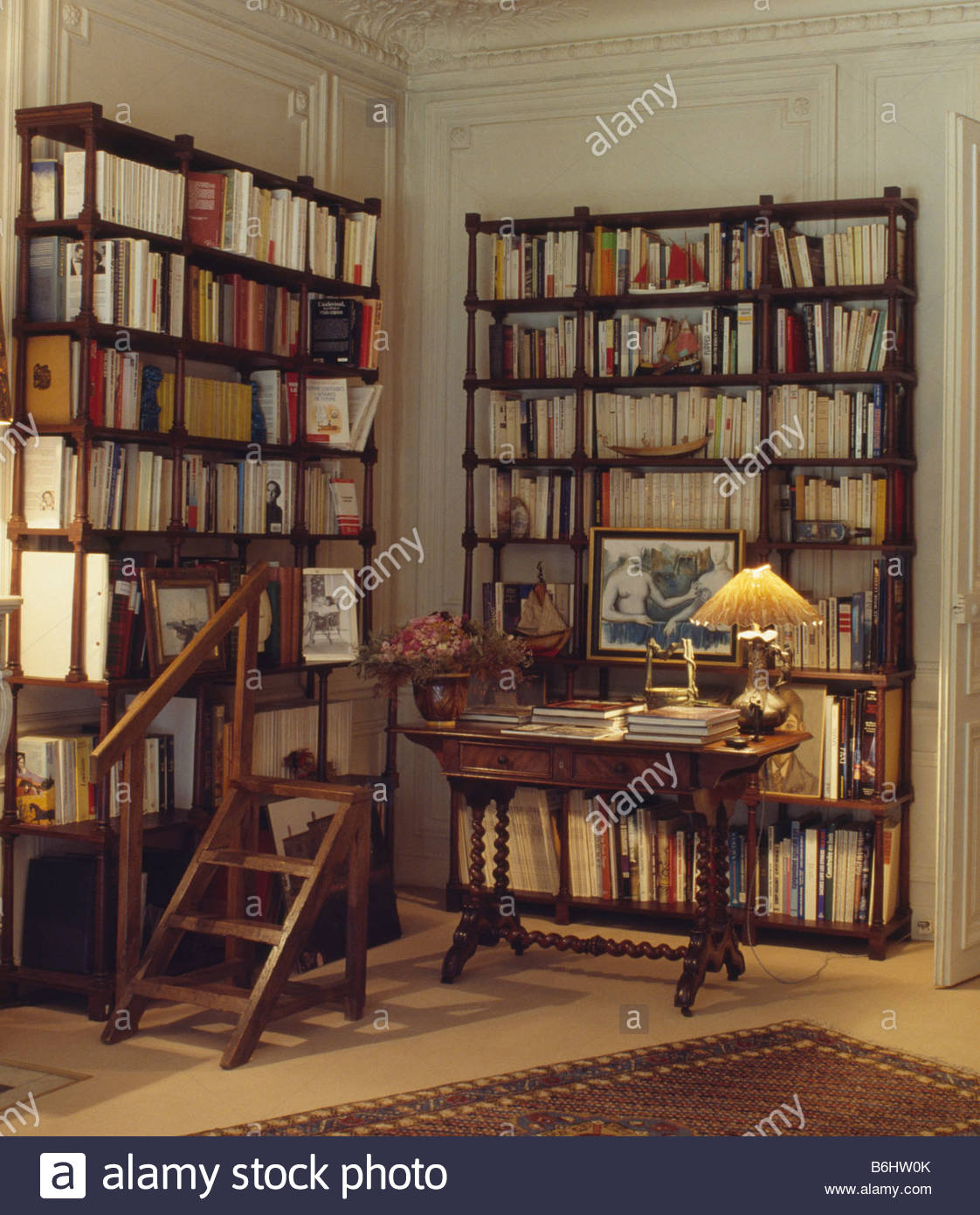 Lighted Lamp On Table In Library Study With Tall Bookshelves intended for measurements 1122 X 1390
